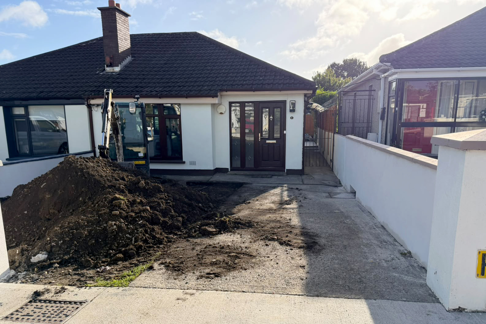 Before photo showing existing concrete driveway and lawn at Oak Court Lawn Dublin 20